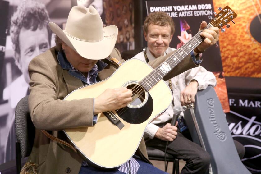 Singer-songwriter Dwight Yoakam, left, and Martin & Co. CEO Chris Martin IV at the 2017 NAMM Show opening day at Anaheim Convention Center on Thursday in Anaheim.