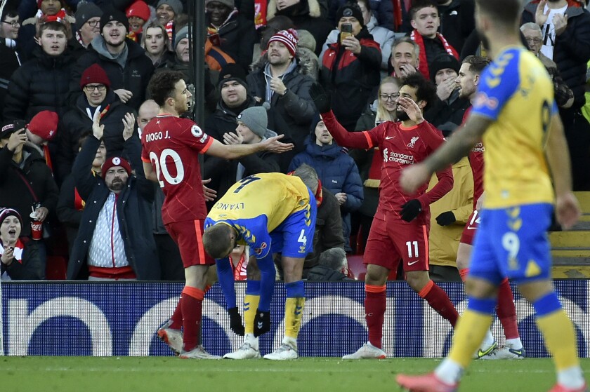 Liverpool's Diogo Jota, left, celebrates after scoring his side's second goal during the Premier League soccer match between Liverpool and Southampton at Anfield stadium, in Liverpool, England, Saturday, Nov. 27, 2021. (AP Photo/Rui Vieira)