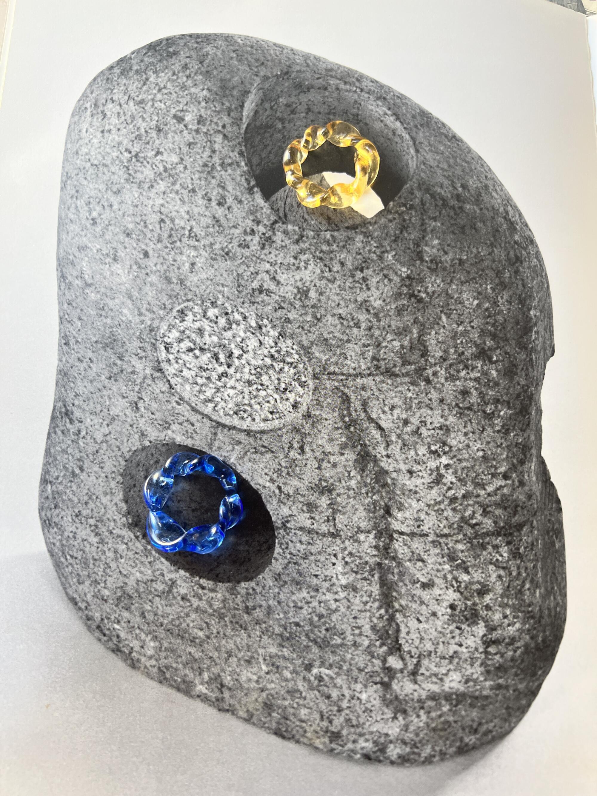 Two glass rings in yellow and blue by Georgia ic25 displayed in rock-like packaging