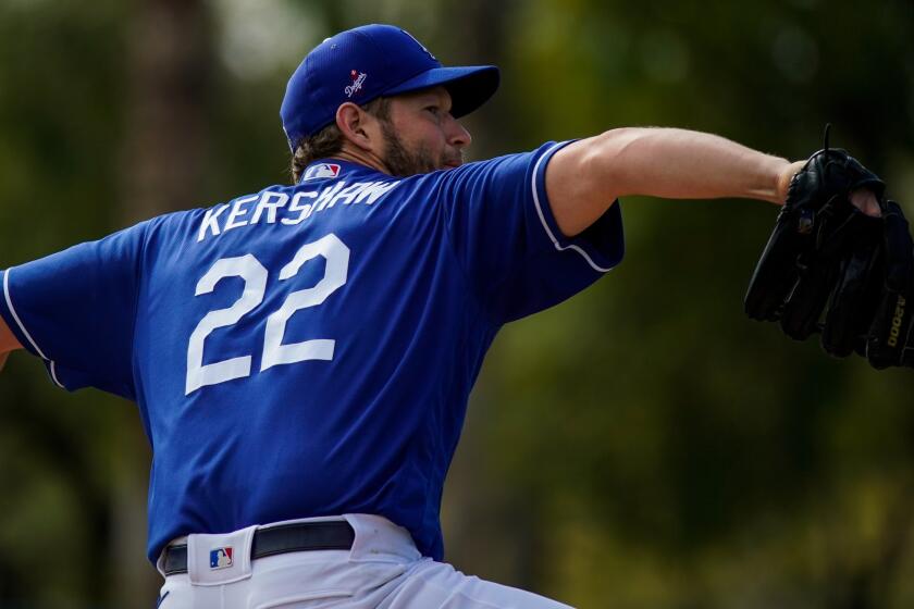 PHOENIX, ARIZ. - FEBRUARY 23: Los Angeles Dodgers pitcher Clayton Kershaw (22), throws a pitch during live batting practice during a Spring Training, before a game against the Chicago Cubs at Camelback Ranch on Sunday, Feb. 23, 2020 in Phoenix, Ariz. (Kent Nishimura / Los Angeles Times)