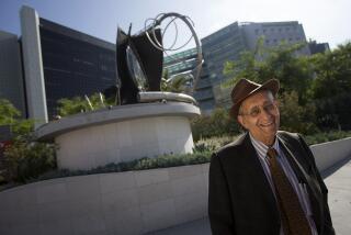 LOS ANGELES, CALIF. - JUNE 28, 2014. Artist Frank Stella stands beside hs scuplture, "adjoeman," which was created in 2004. The sculpture has been installed at the intersection of Beverly and San Vicente Boulevards, in front of Cedars-Sinai Medical Center. (Luis Sinco/Los Angeles Times)