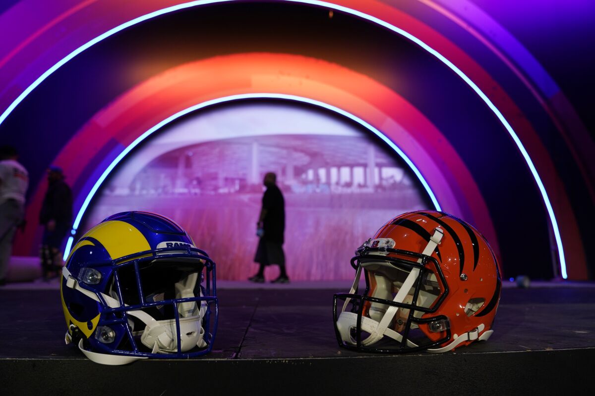 Los Angeles Rams and Cincinnati Bengals helmets rest on a stage inside the NFL Experience.