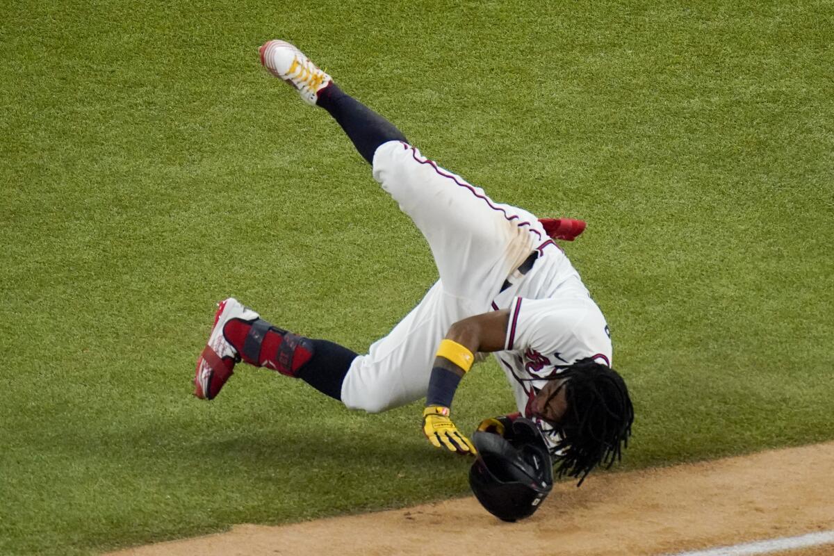 Atlanta's Ronald Acuna Jr. takes a tumble at first base during the sixth inning.