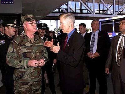 Governor Gray Davis talks with Jacob Van Goor of the Army National Guard 40th Infantry Div. in the United Airlines Terminal at Los Angeles International Airport.