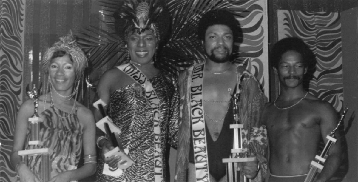 Miss and Mr. Black Beauty at Ball Express (Norma and Arnold) and unidentified runners-up holding their trophies in 1976.