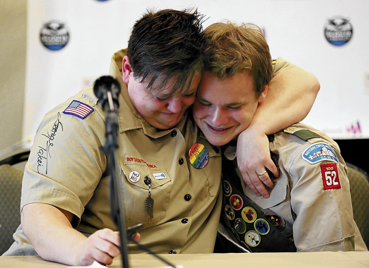 Jennifer Tyrrell hugs Pascal Tessier in May at a news conference in Grapevine, Texas, marking the end of the Boy Scouts' ban on openly gay youths. Tyrrell's ouster as a lesbian Cub Scout den leader will remain in effect.
