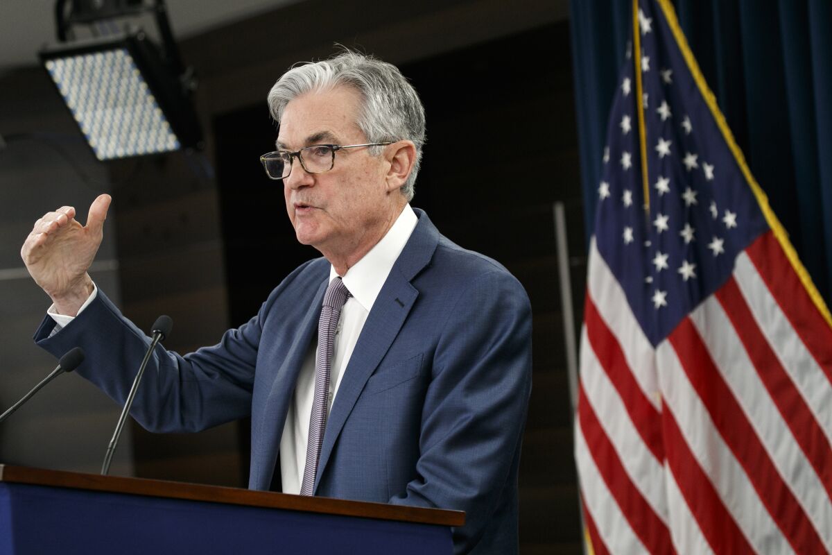 Federal Reserve Chair Jerome Powell speaks at a lectern.