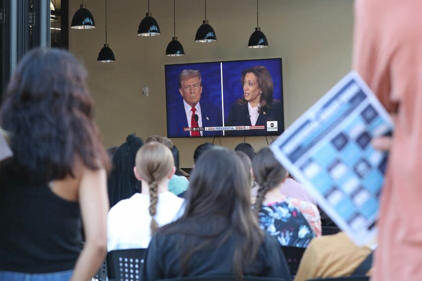 A political science student holds his BINGO card, which was used to critically identify examples of tactics that make politics personal and incite anger or hostility between parties, during presidential debate watch party at Price Room on the Vanguard University college campus, Tuesday evening.