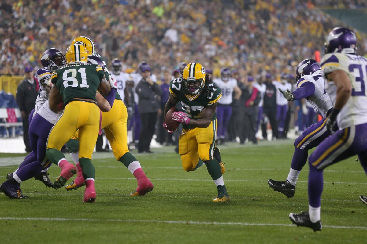 Green Bay's Eddie Lacy runs for a touchdown during the Packers' 42-10 trouncing of Minnesota on Thursday night.