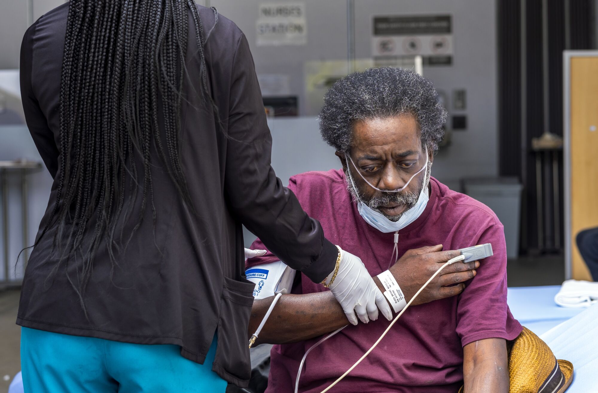 A nurse checks the blood pressure of a patient