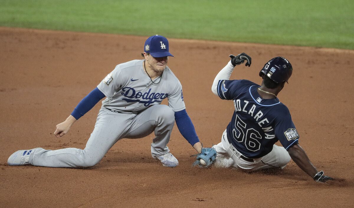Dodgers second baseman Kiké Hernández tags out Tampa Bay baserunner Randy Arozarena on a stolen base attempt.