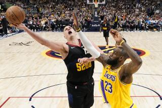 Denver Nuggets center Nikola Jokic (15) goes up for a shot against Los Angeles Lakers forward LeBron James