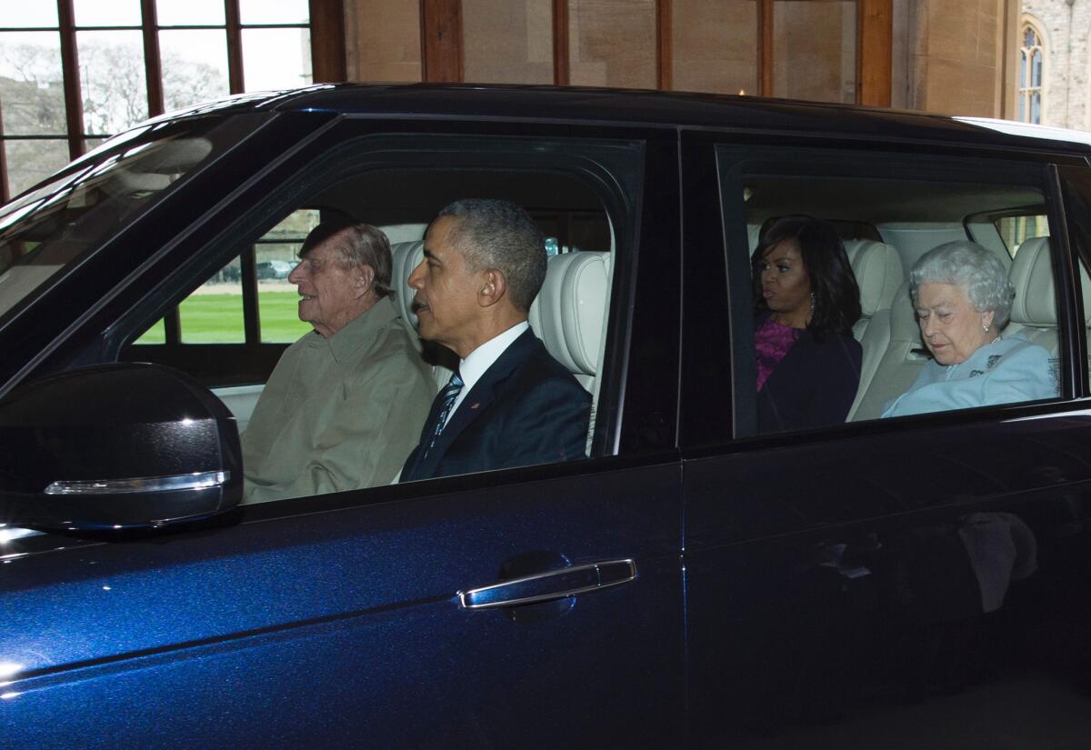 Britain's Prince Philip, duke of Edinburgh, drives President Obama, First Lady Michelle Obama and Britain's Queen Elizabeth II into Windsor Castle after the Obamas arrived for a private lunch Friday.