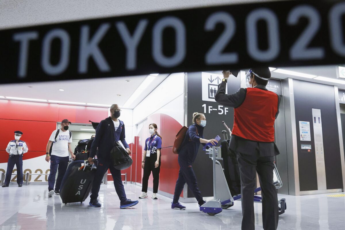 The Olympic athletes from the United States arrive at Narita International Airport in Narita, east of Tokyo, on July 1, 2021. Tens of thousands of visiting athletes, officials and media are descending on Japan for a Summer Olympics unlike any other. There will be no foreign fans, no local fans in Tokyo-area venues. A surge of virus cases has led to yet another state of emergency. (Kyodo News via AP)