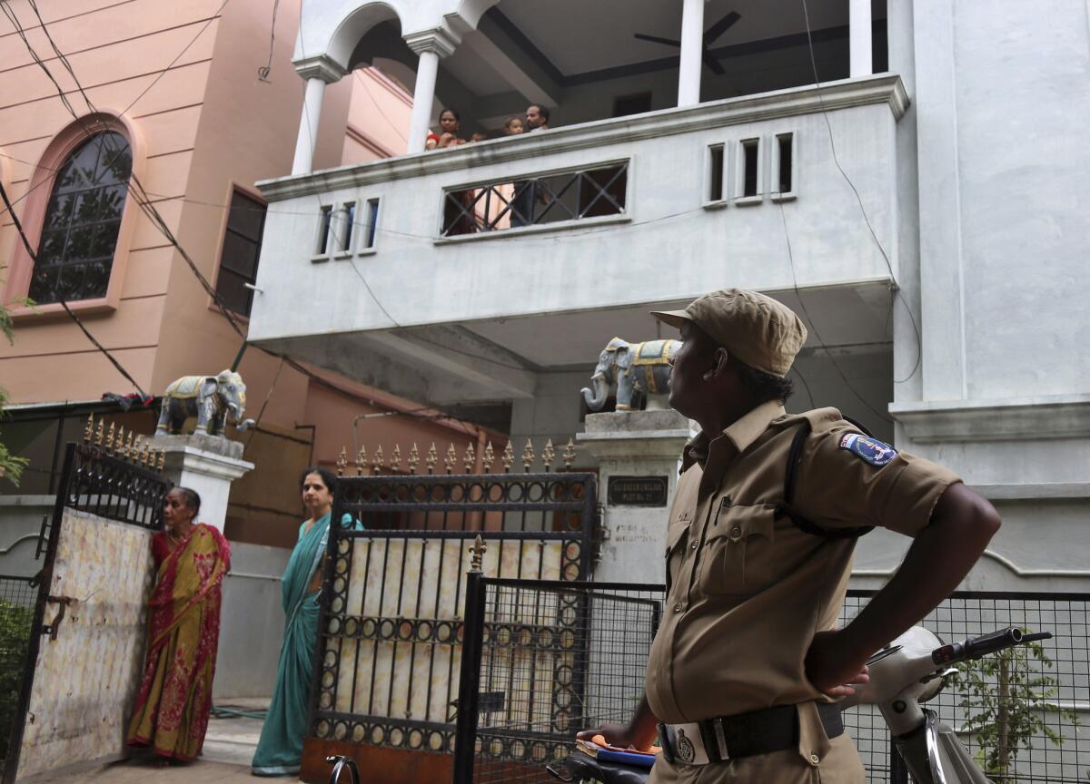An Indian police officer stands outside the Hyderabad residence of one of the Indian nationals who went missing in the Libyan city of Sirte on July 30.
