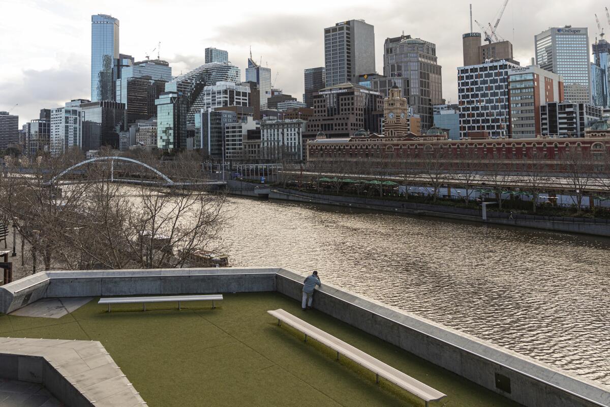 A man looks toward the Yarra River and empty business district during a COVID-19 lockdown in Melbourne, Australia. 