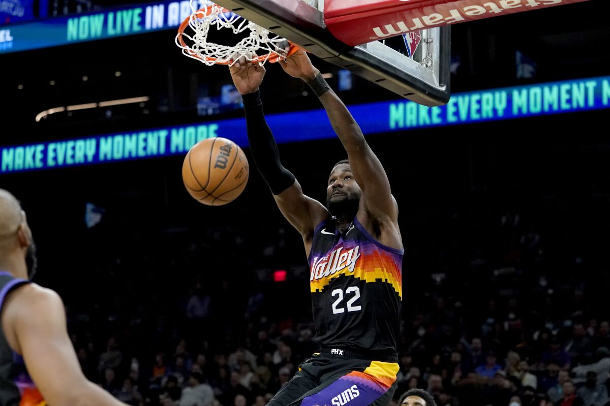 Phoenix Suns center Deandre Ayton (22) dunks against the Brooklyn Nets during the second half of an NBA basketball game, Tuesday, Feb. 1, 2022, in Phoenix. The Suns defeated the Nets 121-111. (AP Photo/Matt York)