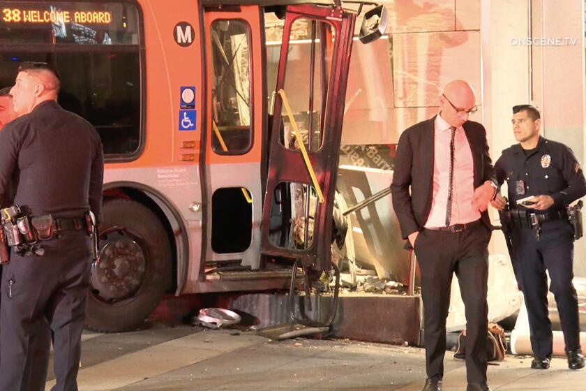 A man is in custody today after he allegedly threatened a Metro bus driver with a gun and caused the bus to crash into several parked vehicles and the side of The Ritz-Carton Hotel in downtown Los Angeles on March 20, 2024.