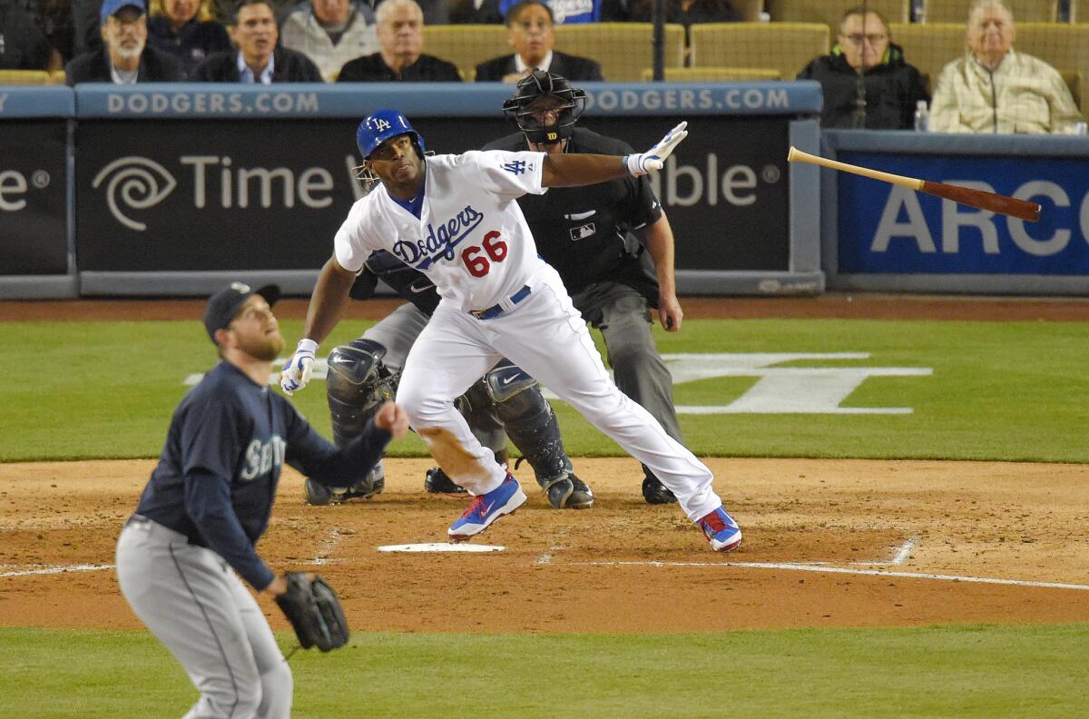 Yasiel Puig hits a solo home run off of Seattle pitcher James Paxton during the fifth inning of the Dodgers' 6-5 victory over the Mariners in 10 innings.