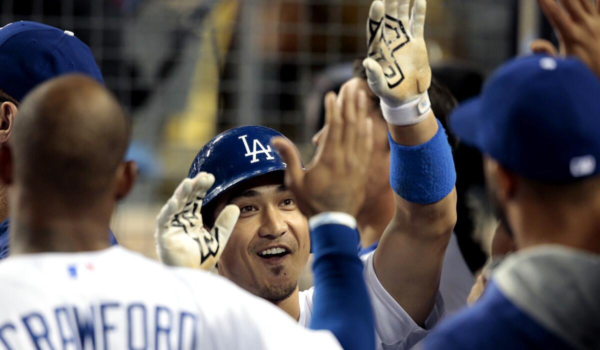 Dodgers second baseman Darwin Barney is all smiles Friday night as he celebrates in the sixth inning, when he led off with a single and scored and then closed the six-run rally with a sacrifice fly.
