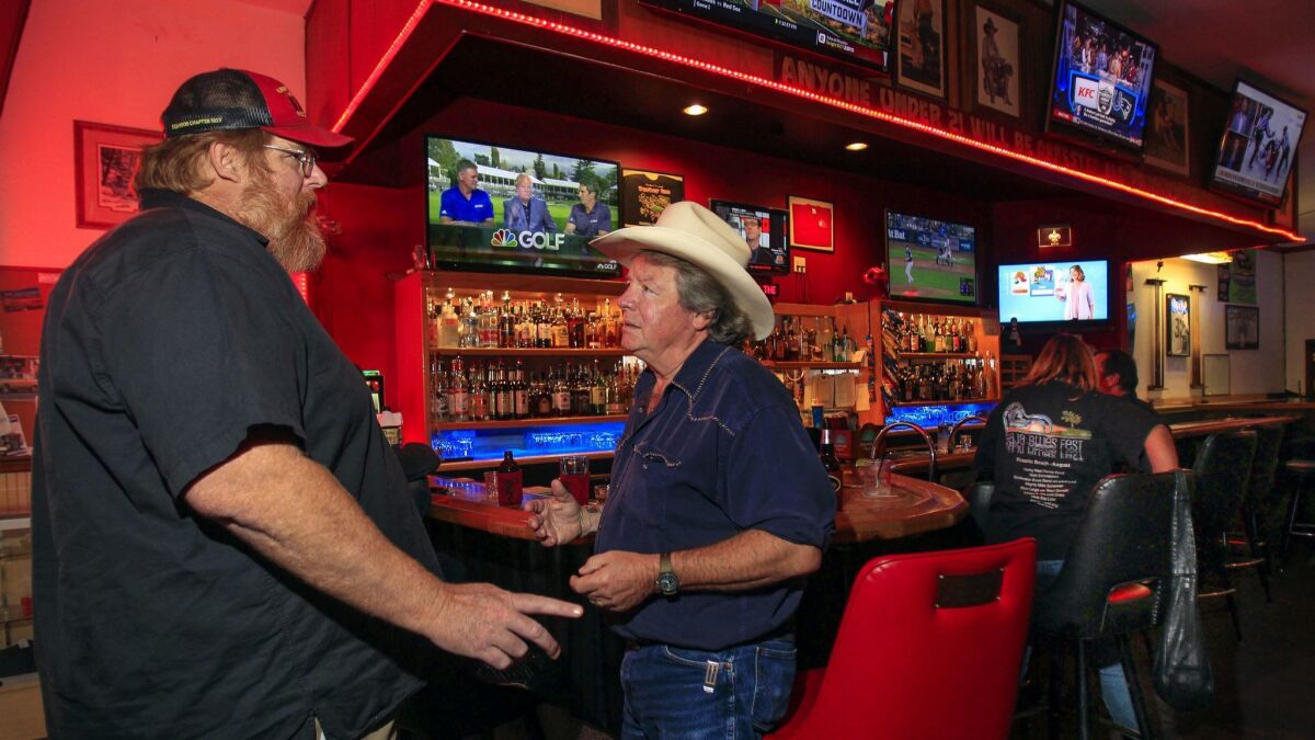Pete Beauregard, center, who ran as a Democrat in the 50th Congressional District, talks to Larry Miller at the Turkey Inn.