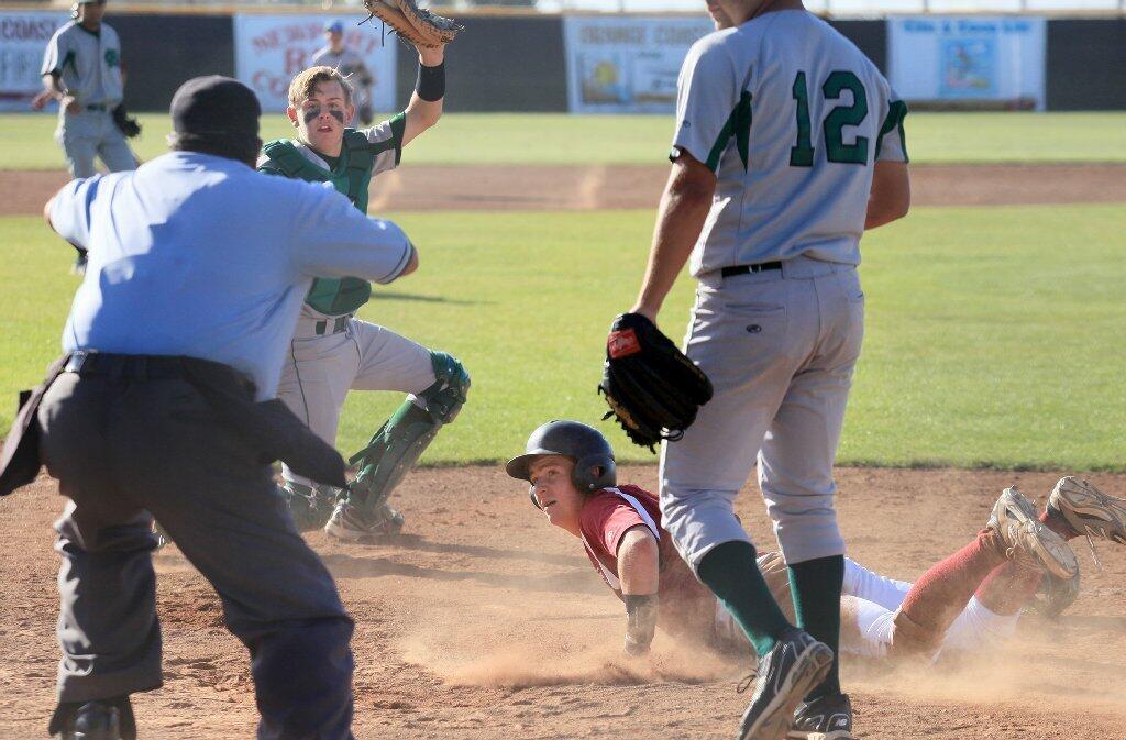 Costa Mesa High catcher James Barton, top left, prevents Estancia's Colin Gardner, bottom right, from scoring a third run during the sixth inning on Wednesday.
