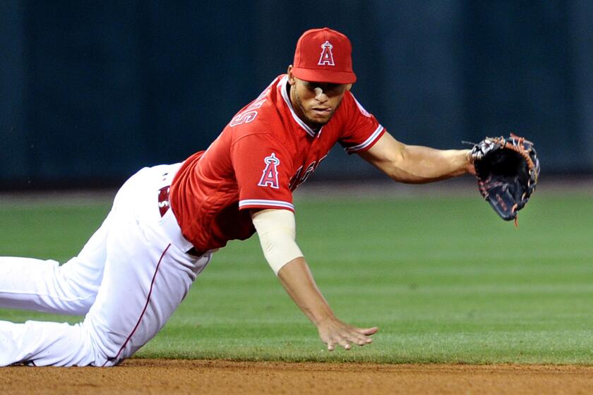 Angels shortstop Andrelton Simmons dives for a ball hit by the Cubs' Jorge Soler during a game April 4.