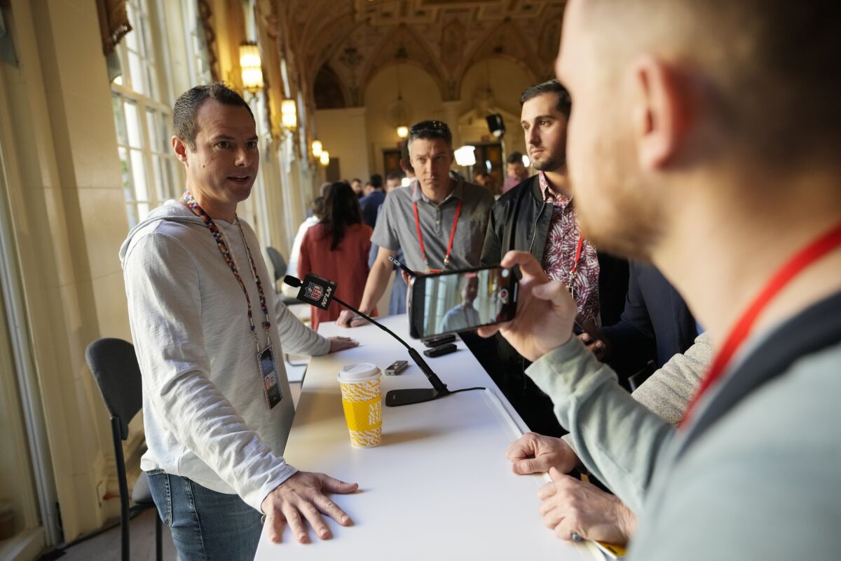 Chargers coach Brandon Staley, left, speaks to journalists during availability at the NFL's annual meeting.