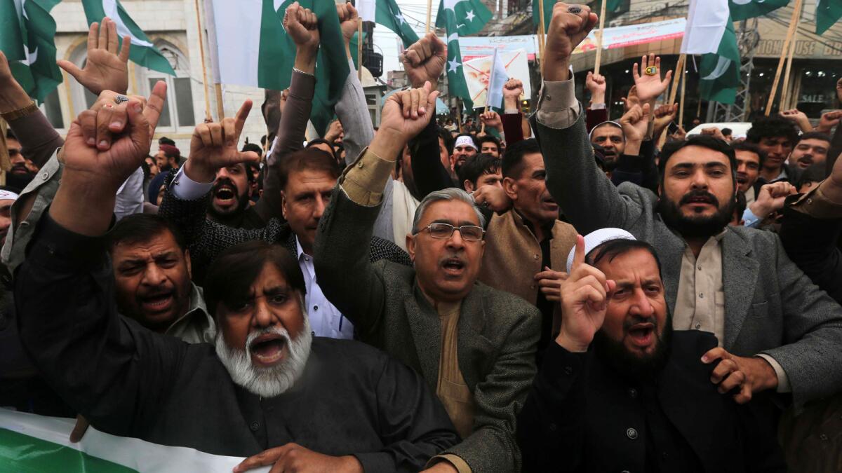 Pakistanis shout anti-India slogans as they protest in Peshawar on March 1.