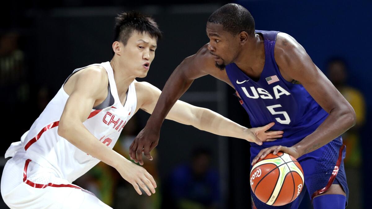 U.S. forward Kevin Durant (5) drives past China's Zou Peng during an Olympic preliminary round basketball game on Saturday.