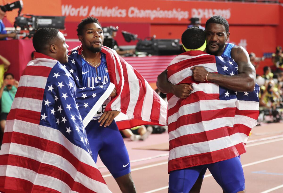 The U.S. men's team celebrates after winning the 400-meter relay on Saturday.