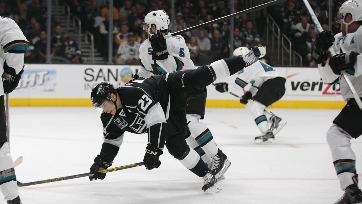 San Jose Sharks defenseman Jason Demers, top, shoves Kings captain Dustin Brown to the ice during the first period of the Kings' 4-0 loss on Oct. 8.