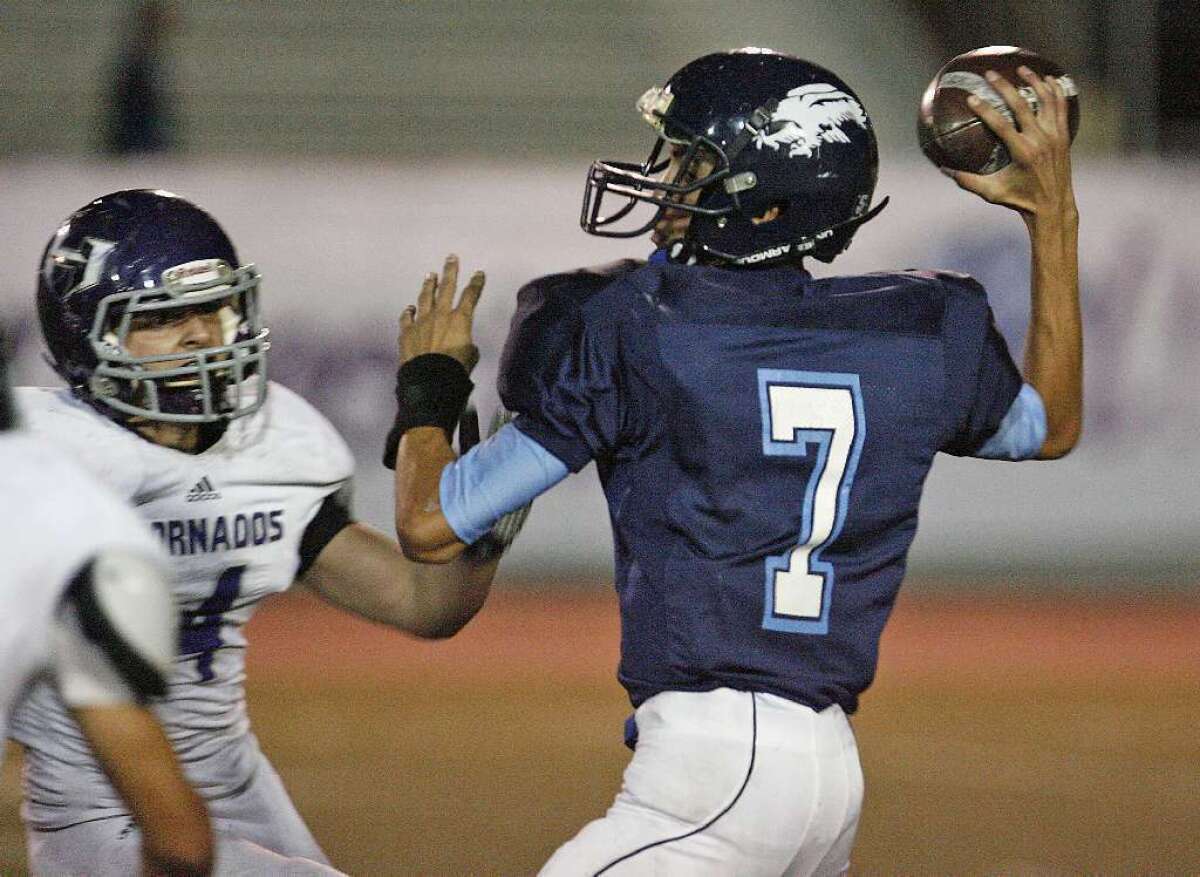 ARCHIVE PHOTO: Crescenta Valley High quarterback Brian Gadsby, right, will look to keep the Falcons' offense clicking in a rivalry game with La Cañada.