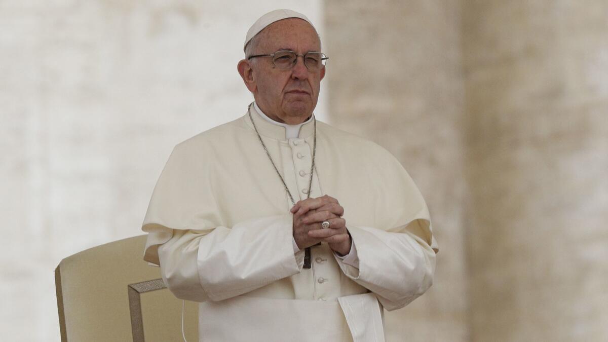 Pope Francis attends his weekly general audience, in St. Peter's Square, at the Vatican on Wednesday.