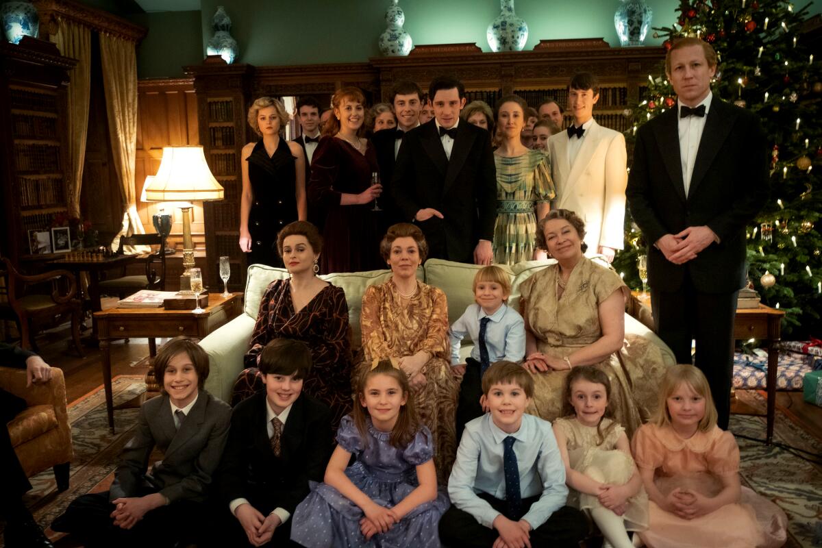 Children and adults pose for a Christmas family photo in "The crown."
