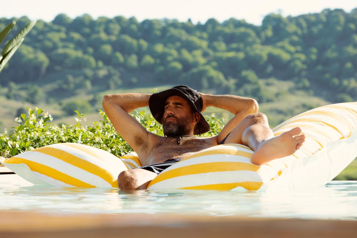 A man reclines on a pool float