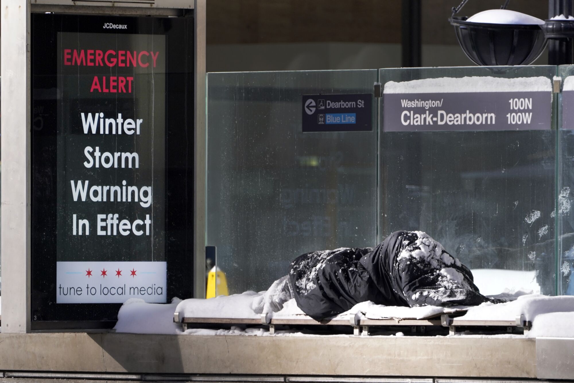 A homeless man sleeps outdoors in Chicago.