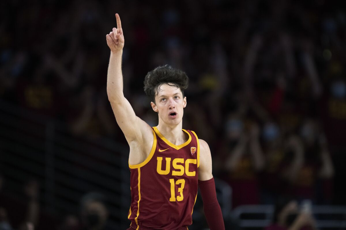 Southern California guard Drew Peterson (13) reacts after scoring a 3-pointer during the first half of the team's NCAA college basketball game against UCLA on Saturday, Feb. 12, 2022, in Los Angeles. (AP Photo/Kyusung Gong)