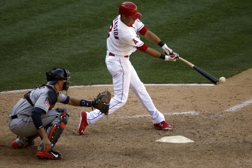Angels third baseman Taylor Featherston hits a walk-off single to beat the Houston Astros, 2-1, in the 13th inning.