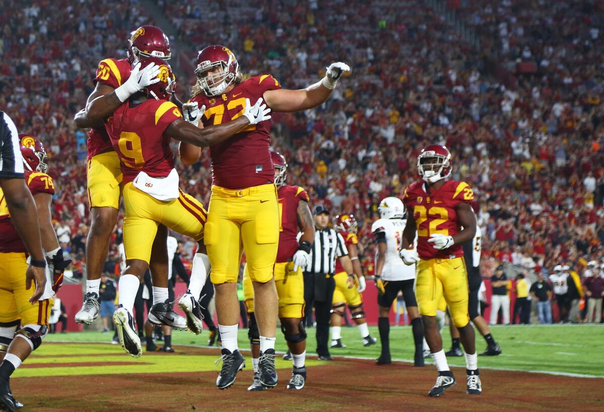 Teammates swarm USC receiver JuJu Smith-Schuster (9) after scoring against Arizona State at the Coliseum on Oct. 1.