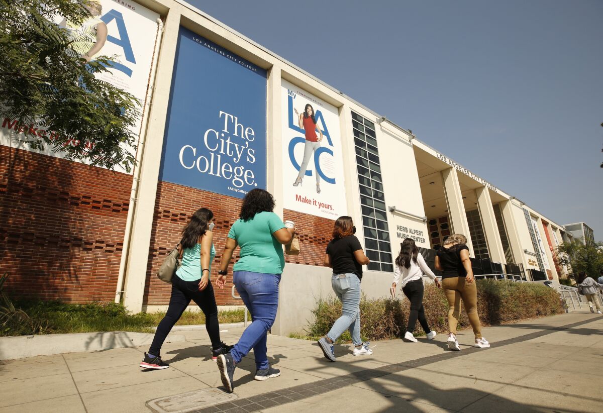 Students walk by a Los Angeles City College building. 