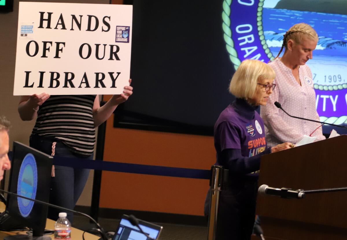 Barbara Richardson, right, speaks against library privatization during Tuesday night's meeting.