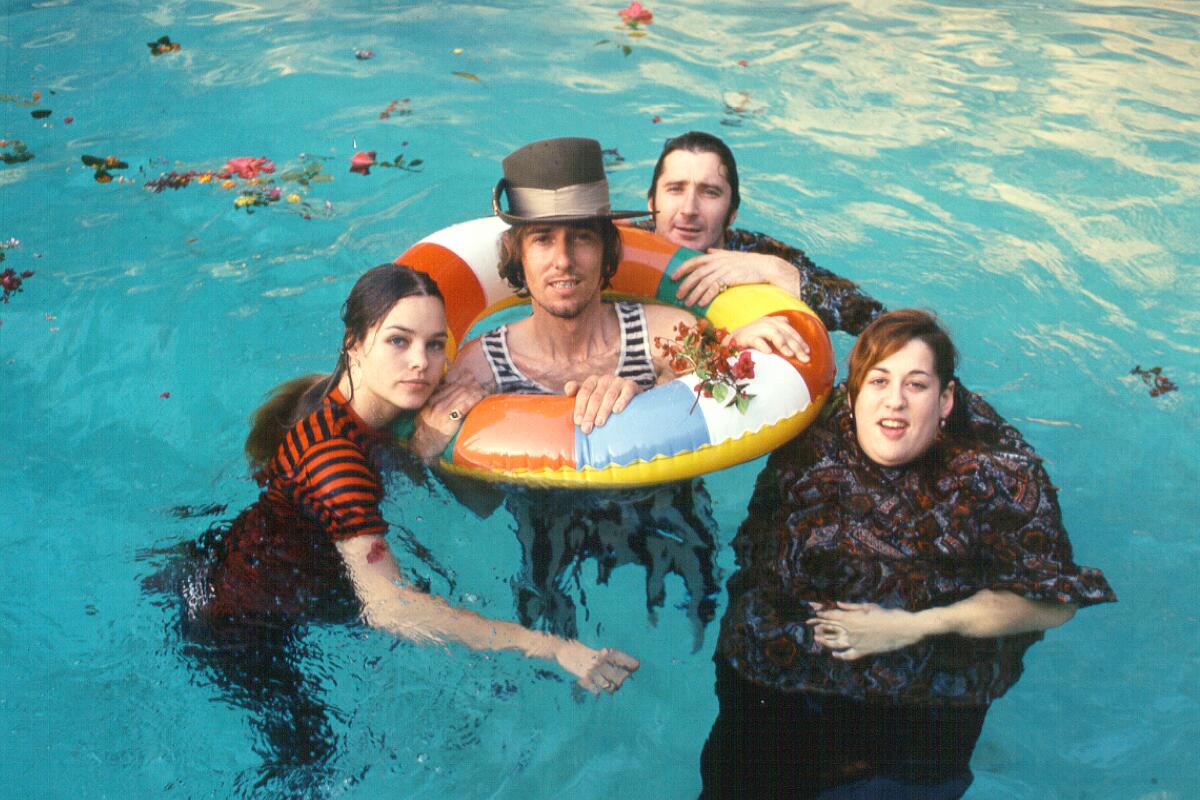 The Mamas and the Papas float in a pool for a publicity shot.