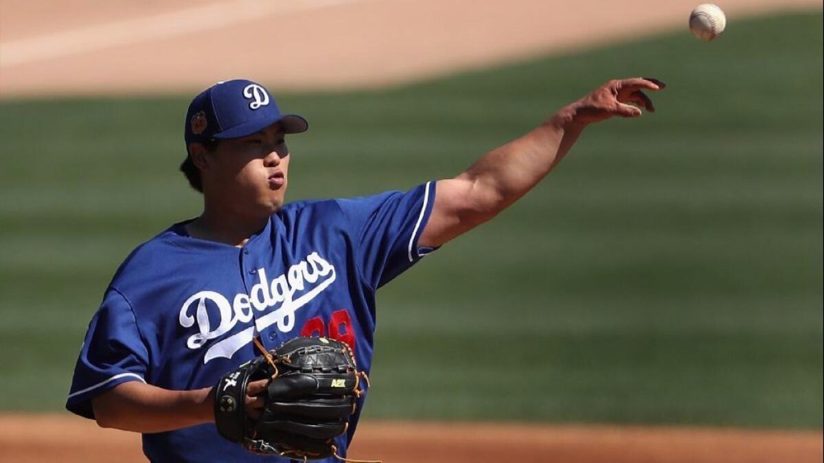 Dodgers pitcher Hyun-Jin Ryu fields a ground ball during the second inning of Saturday's game against the Angels.