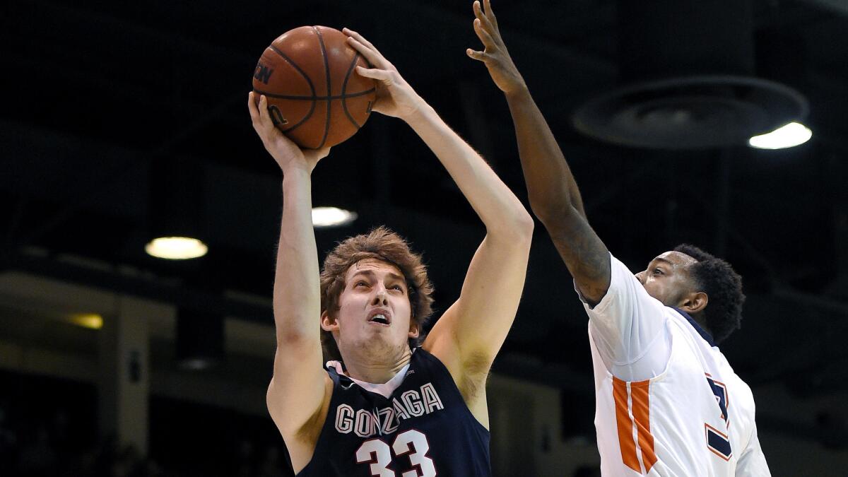 Pepperdine guard Jeremy Major tries to block a shot by Gonzaga forward Kyle Wiltjer during a West Coast Conference game on Feb. 6.