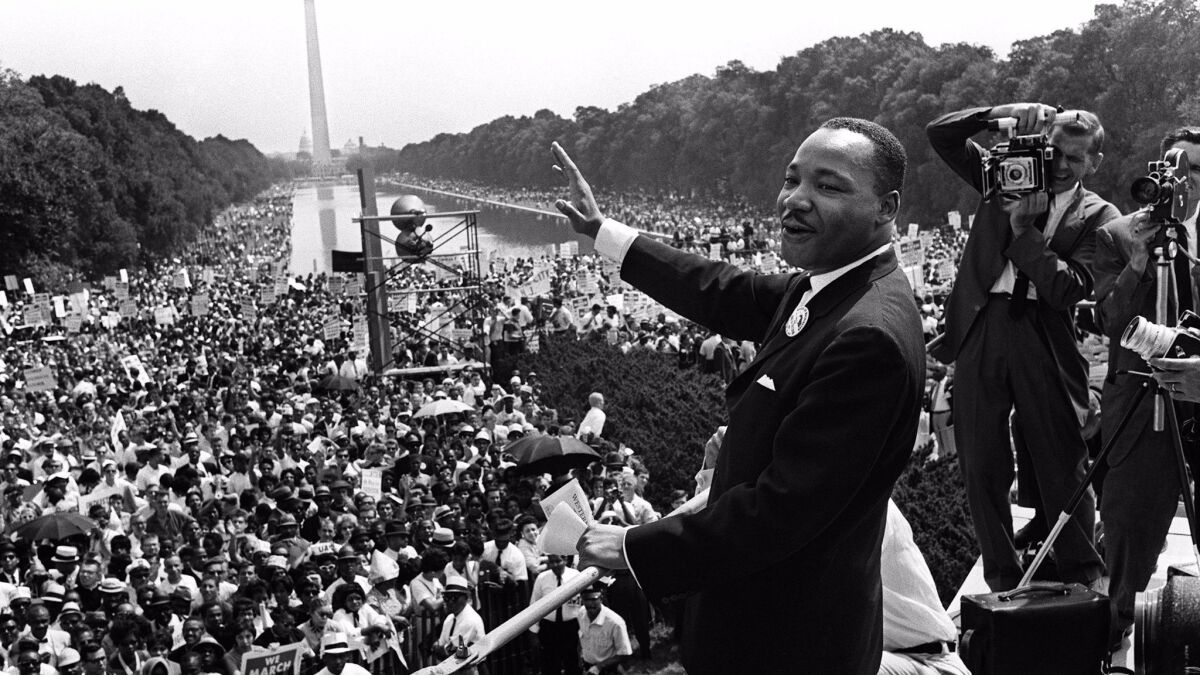 This Aug. 28, 1963, file photo shows civil-rights leader Martin Luther King Jr. waving from the steps of the Lincoln Memorial to supporters on the Mall in Washington, D.C., during the "March on Washington."