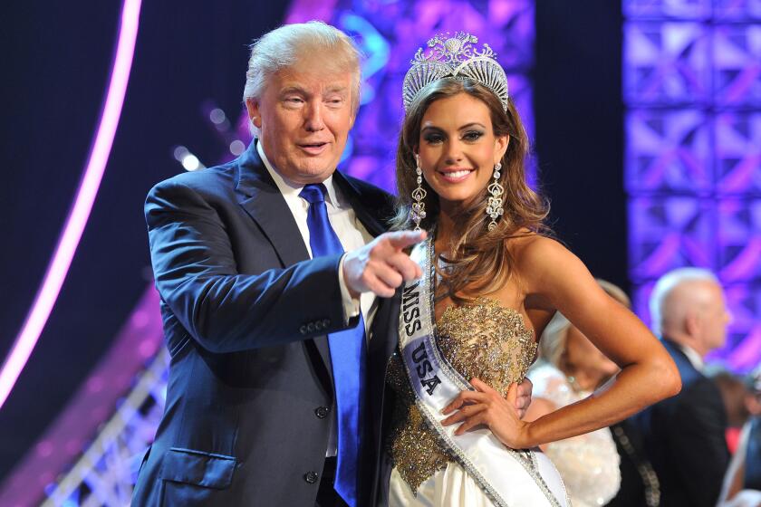 Donald Trump poses in 2013 with Miss USA winner Erin Brady. The Reelz channel says it will air the 2015 pageant after it was dropped by NBC.