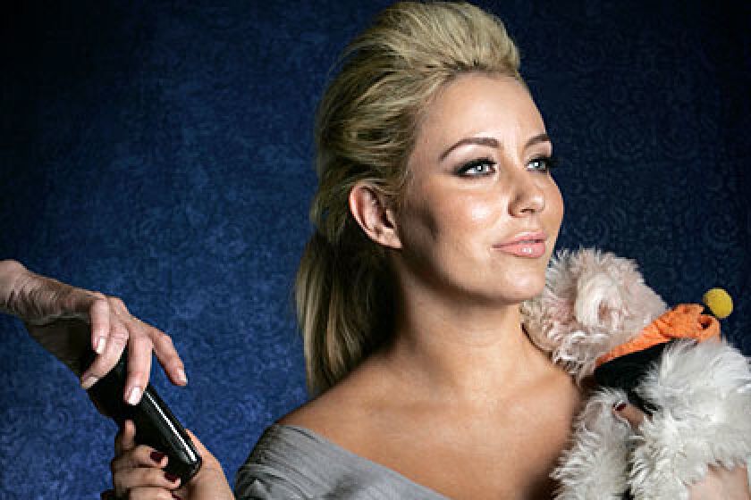 Aubrey O'Day, formerly of music group Danity Kane, and her dog Ginger.