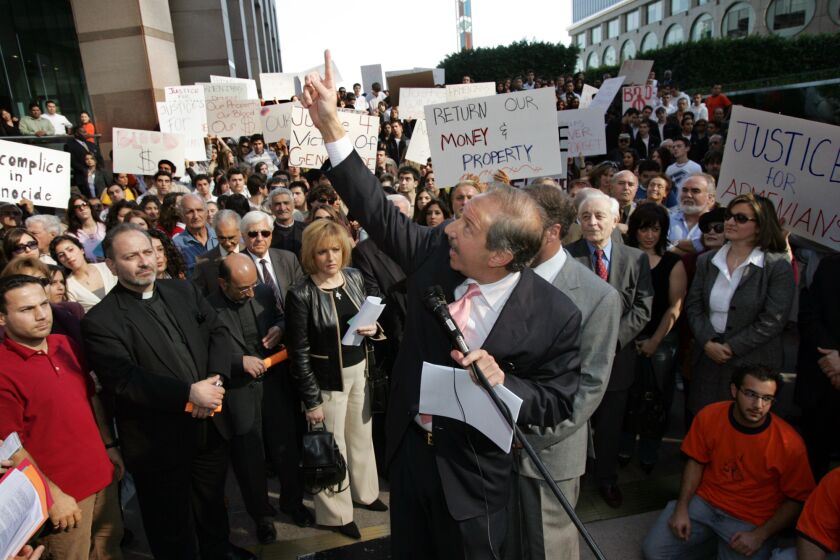 Attorney Mark Geragos points at the Deutsche Bank office in downtown Los Angeles during a press conference where a class action lawsuit against two German banks to seek recovery of money that they allegedly withheld following the Armenian Genocide was announced, Friday, Jan. 13, 2006. (AP Photo/Stefano Paltera)