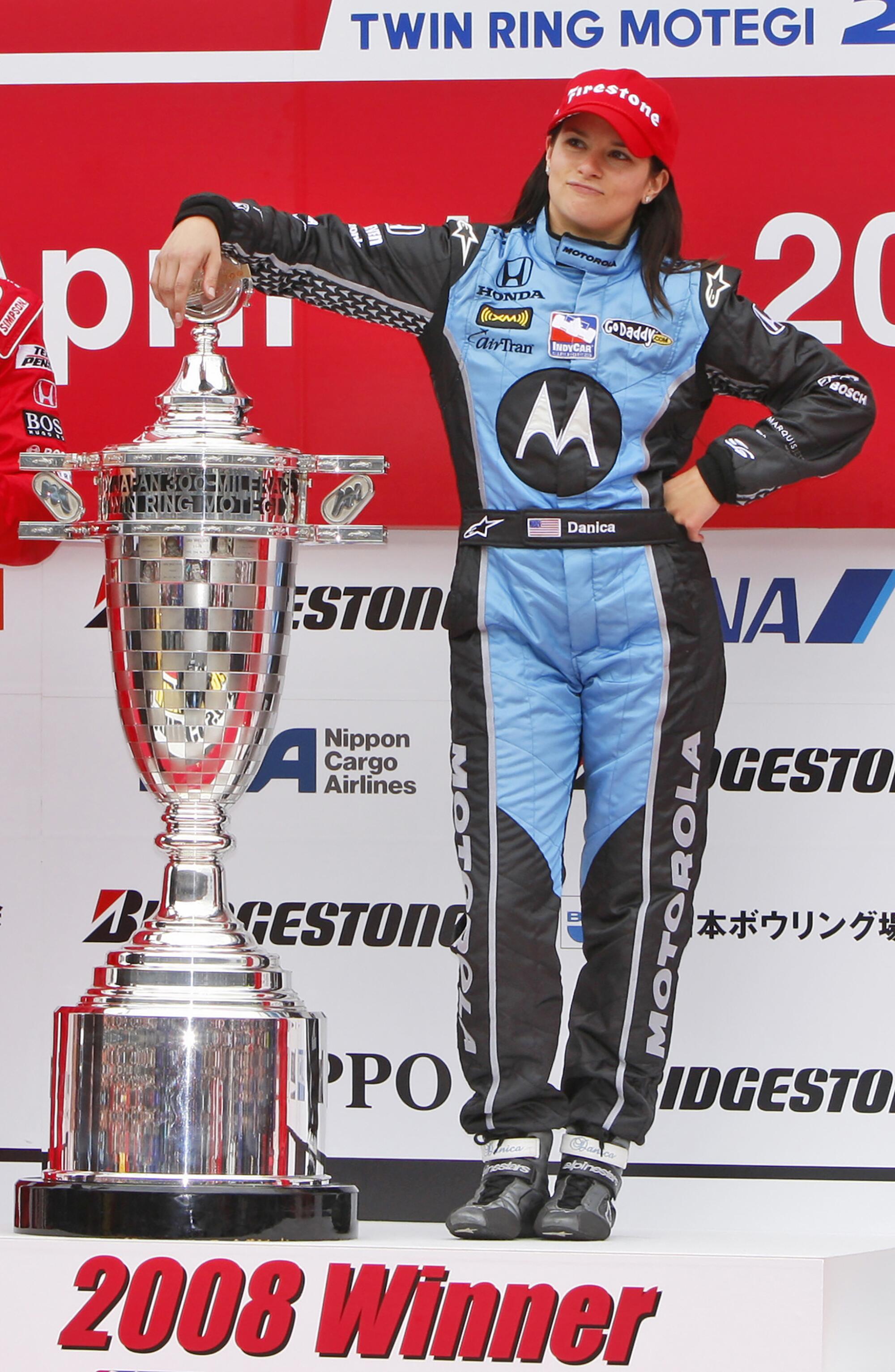 Danica Patrick poses on the podium after winning the Indy Japan 300 at Twin Ring Motegi in April 2008.